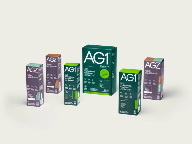 Multiple boxes of AG1 and AGZ wellness supplements arranged against a neutral background