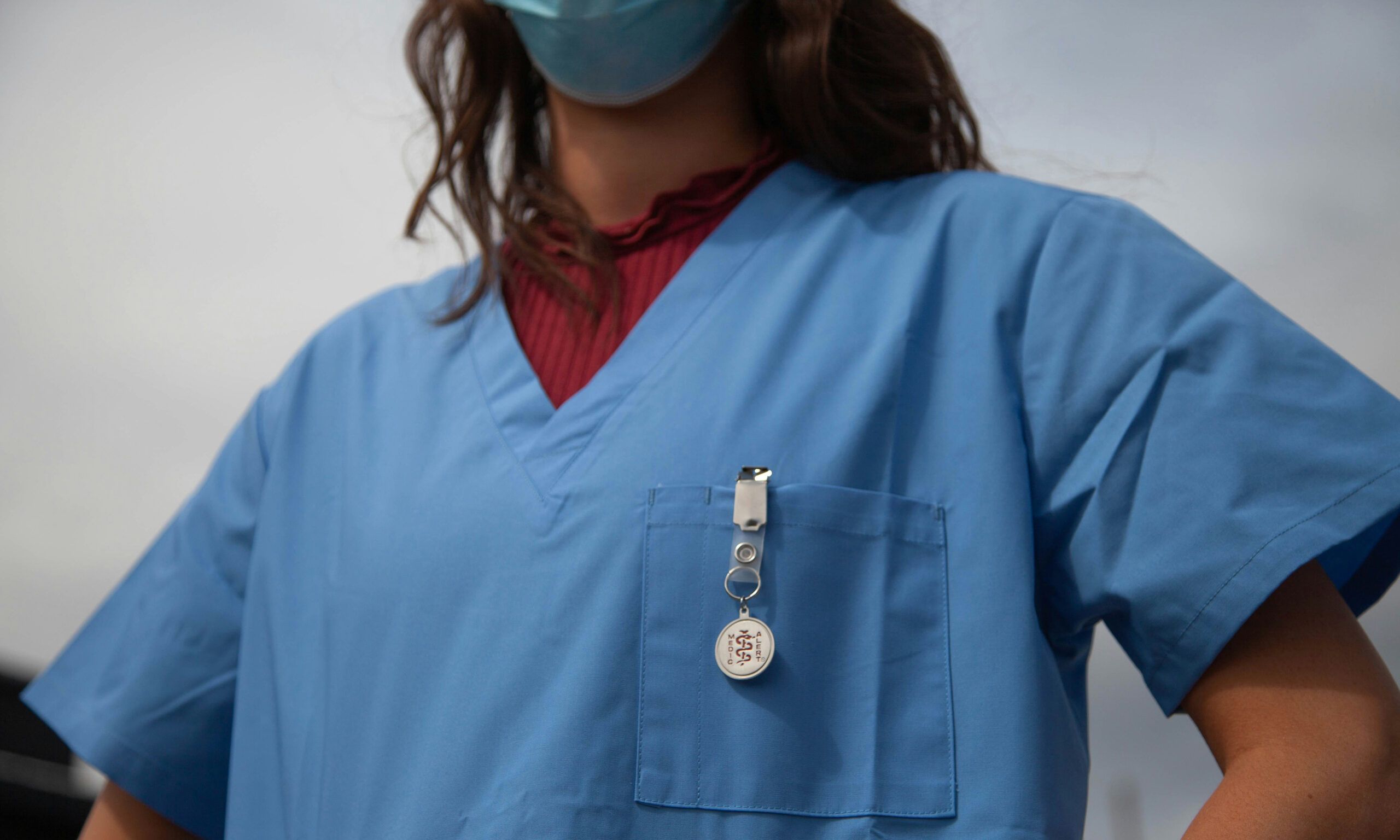 mid view of woman in blue medical scrubs