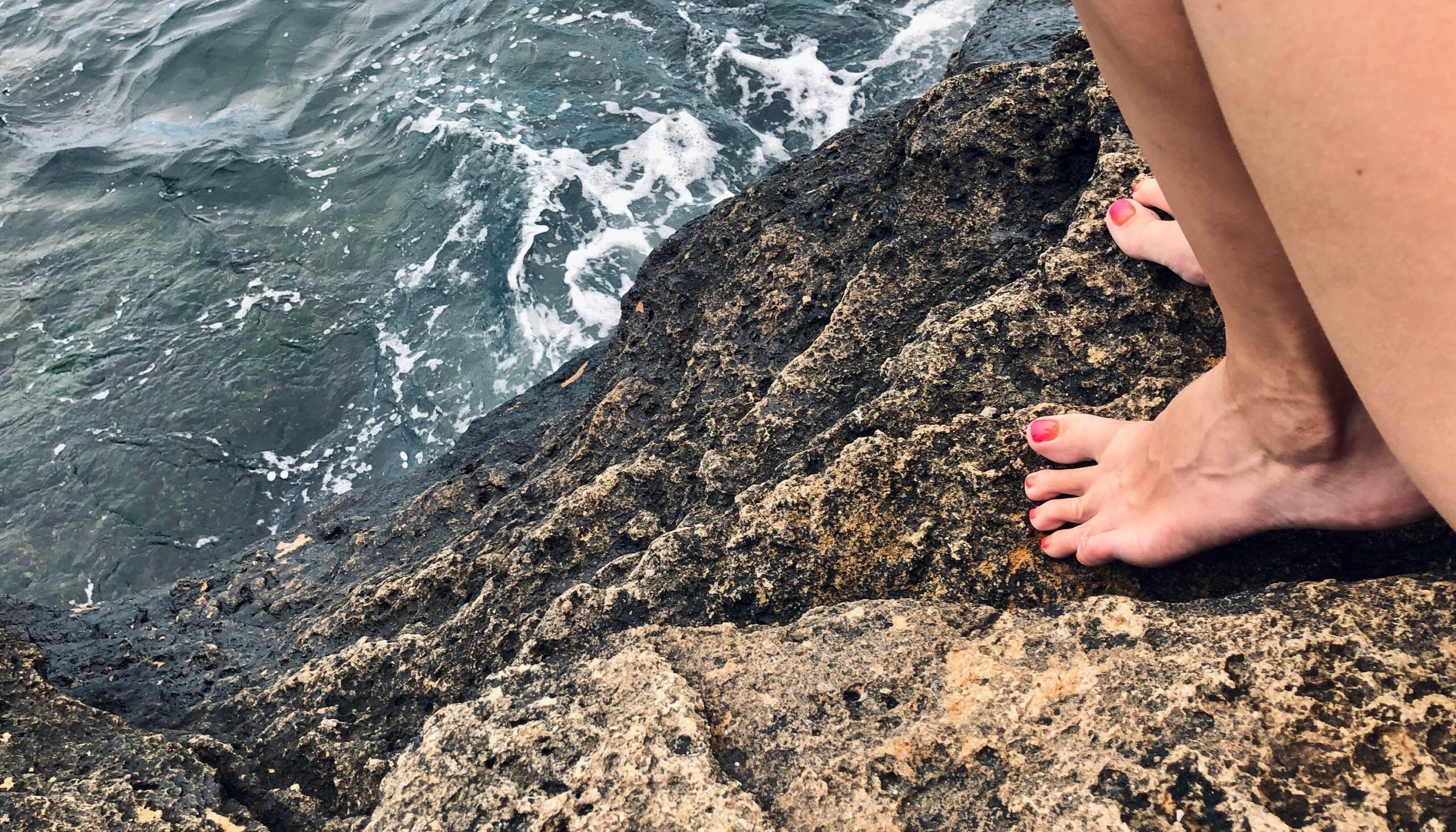 pedicured toes with Nantucket red nail polish