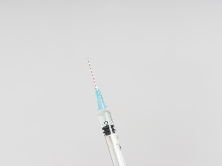 syringe against a gray background