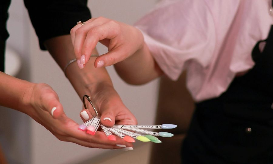 woman picking out gel nail polish color