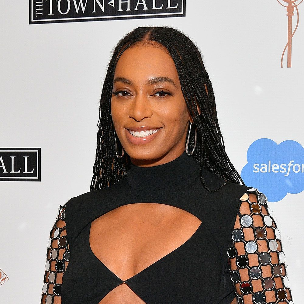 Solange wearing a cut-out and metallic black dress