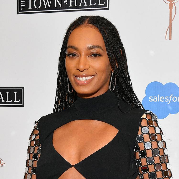 Solange wearing a cut-out and metallic black dress