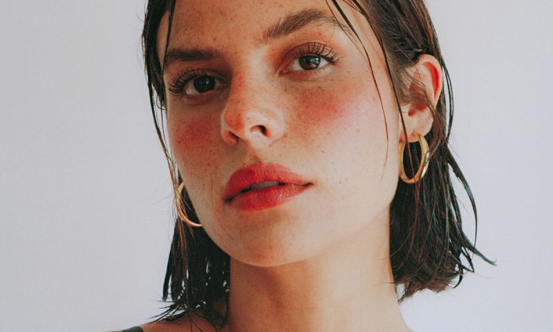 woman's face with bright blush and lipstick