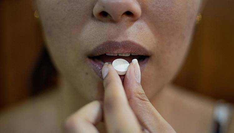 Woman taking a pill
