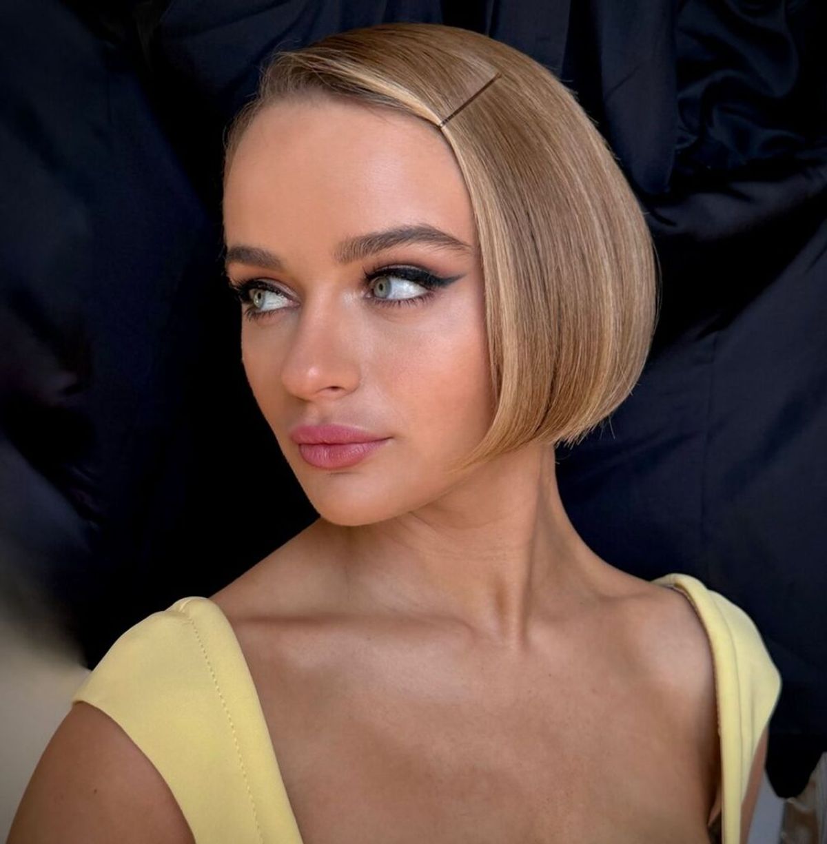 a woman looking over her shoulder with her hair in a short cropped bob hairstyle