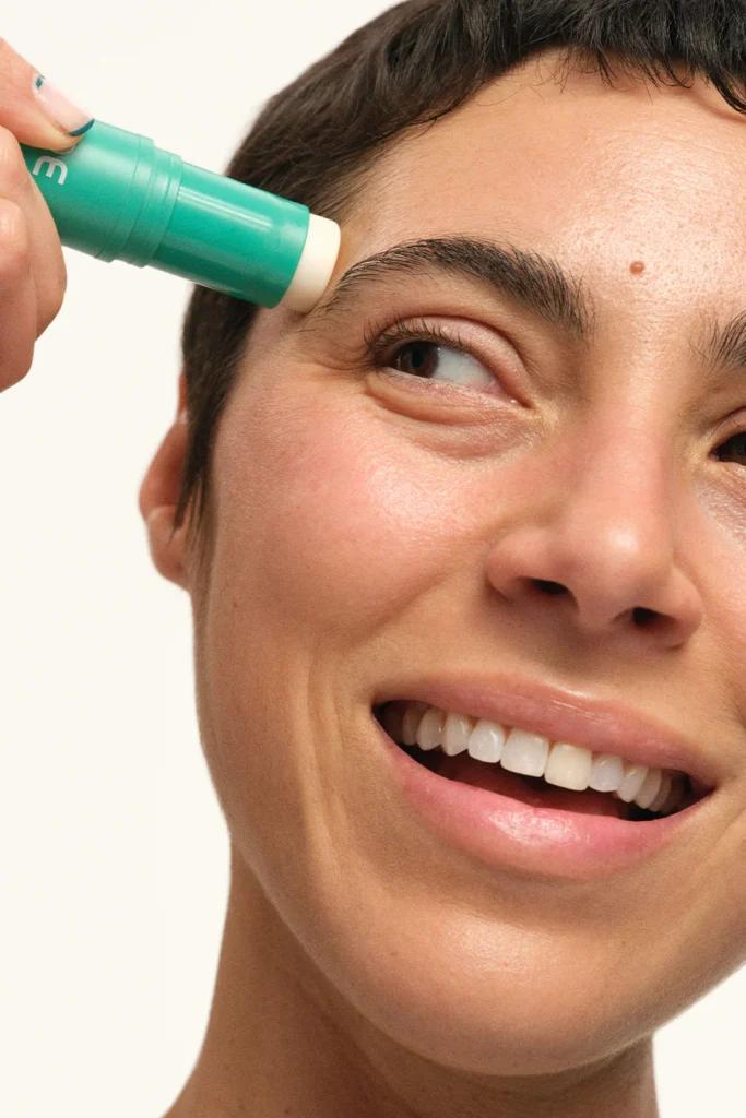 woman using DEINDE Moisture-Locking Face Stick
