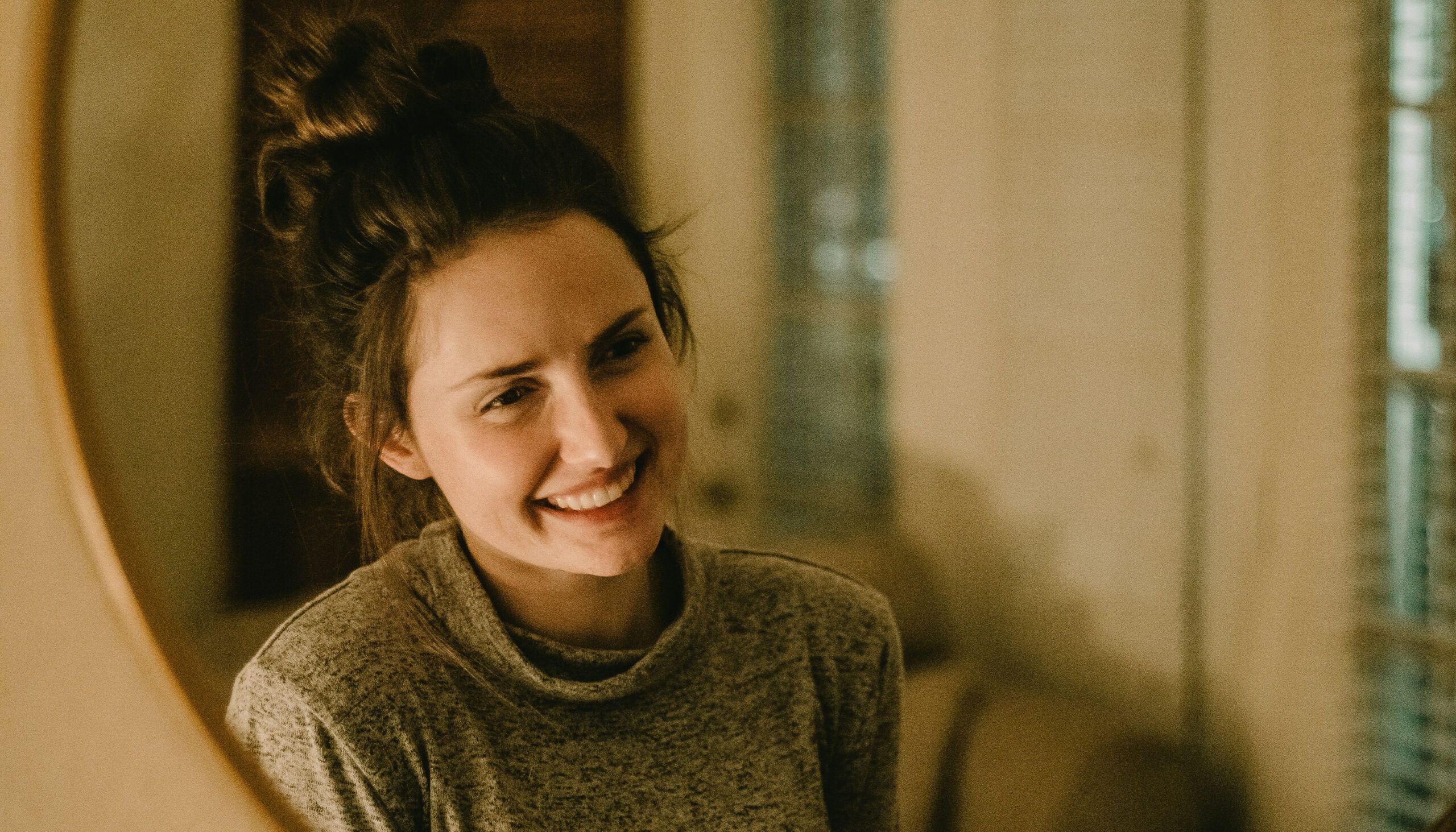 woman smiling in mirror
