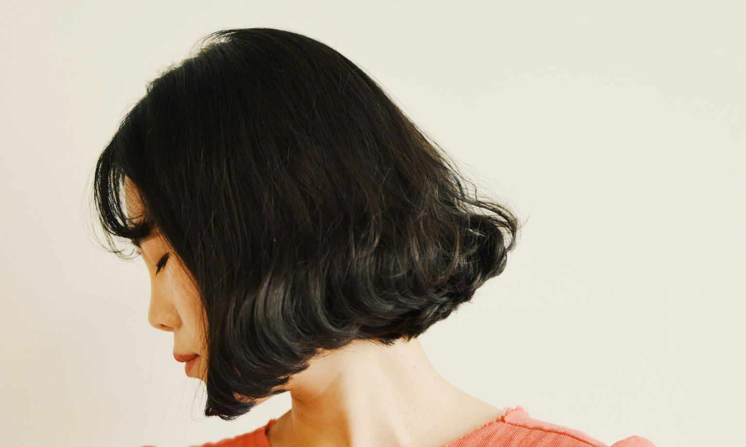 woman with short brown bob looking to the side