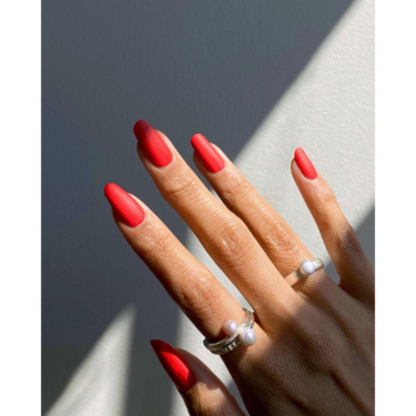 Fingernails with matte red polish