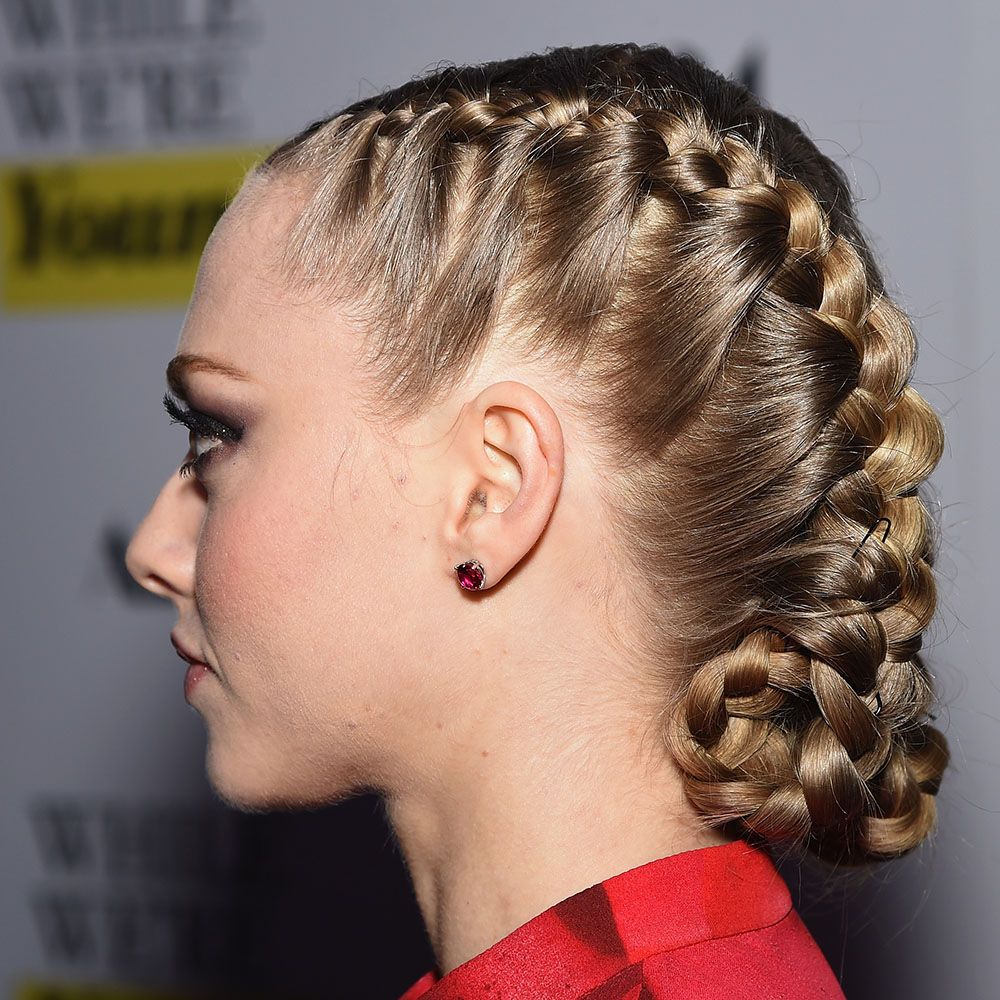 Side view of Amanda Seyfried wearing tucked French braids
