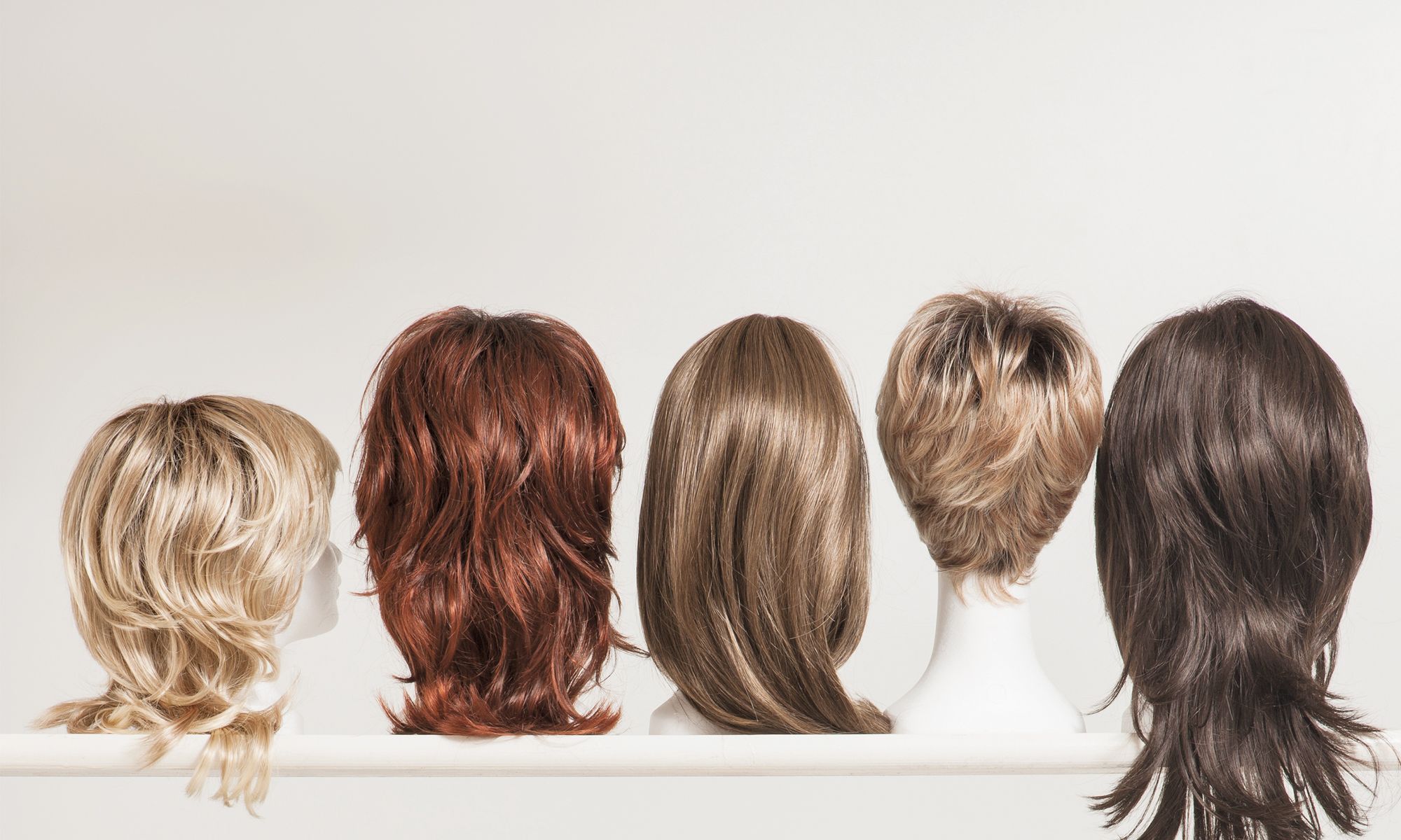 shelf of different hair wigs
