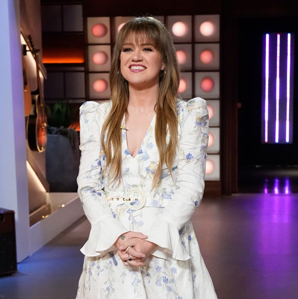 Kelly Clarkson on set of The Voice in a white two-piece outfit