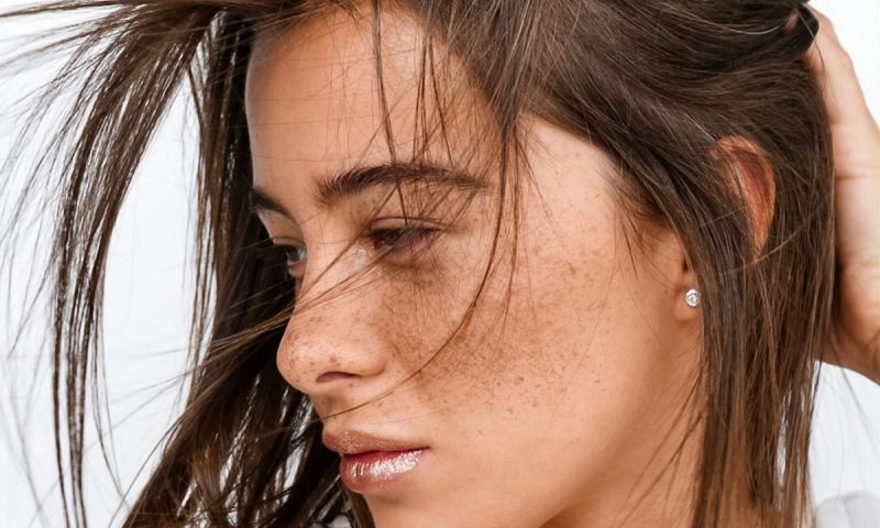 woman with wind-swept brown hair