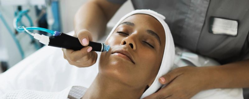 woman receiving cosmetic treatment on face