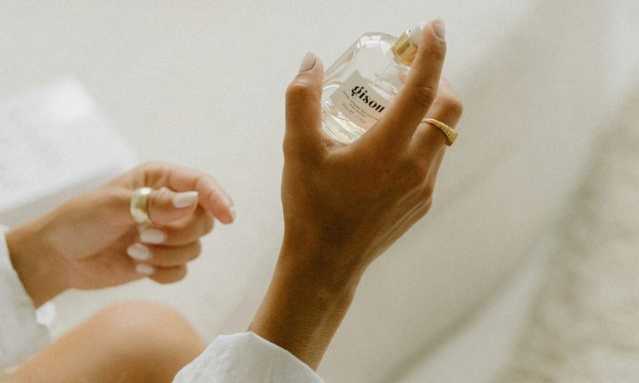 woman holding fragrance bottle