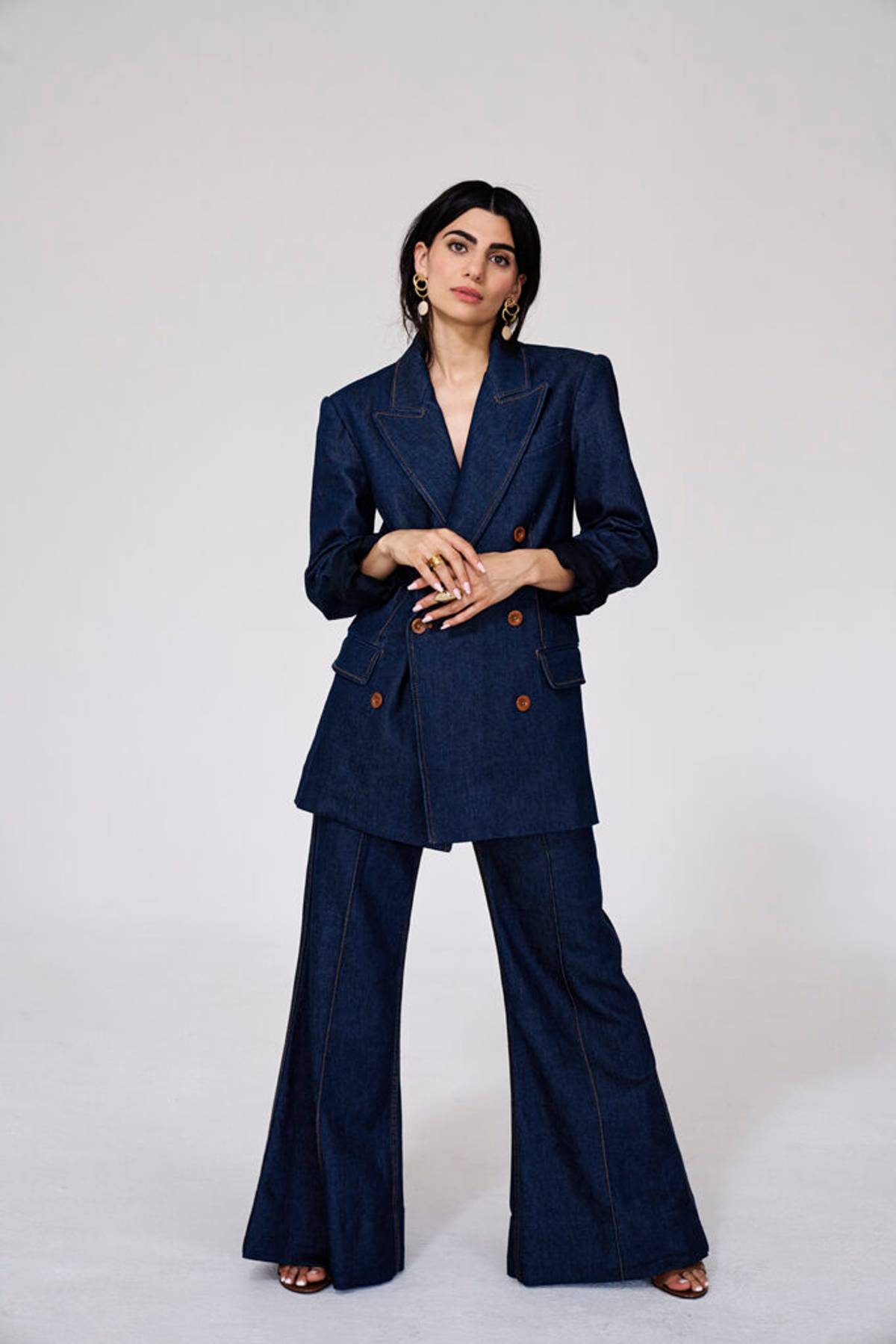 Claudia Doumit posing in a two-piece navy suit