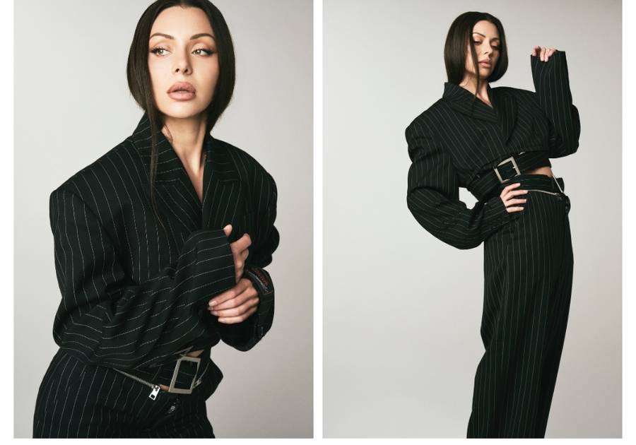 Side-by-side studio portraits of actress Neraida Bega wearing a black pinstripe suit, featuring a close-up beauty look and a full-body pose, highlighting her sleek hair and natural makeup