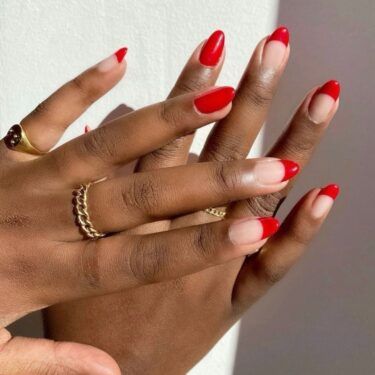 close-up of oval nails with red French tips