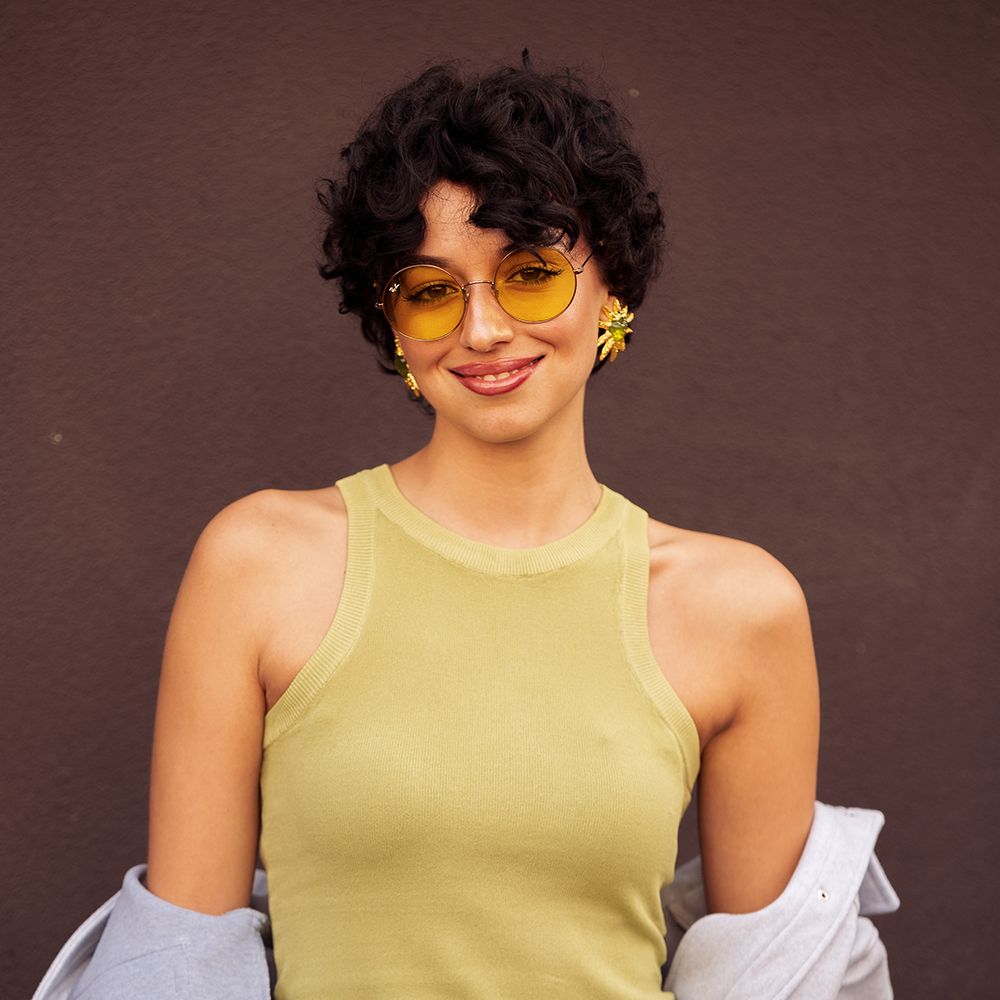 Photo of short-haired woman wearing yellow sunglasses
