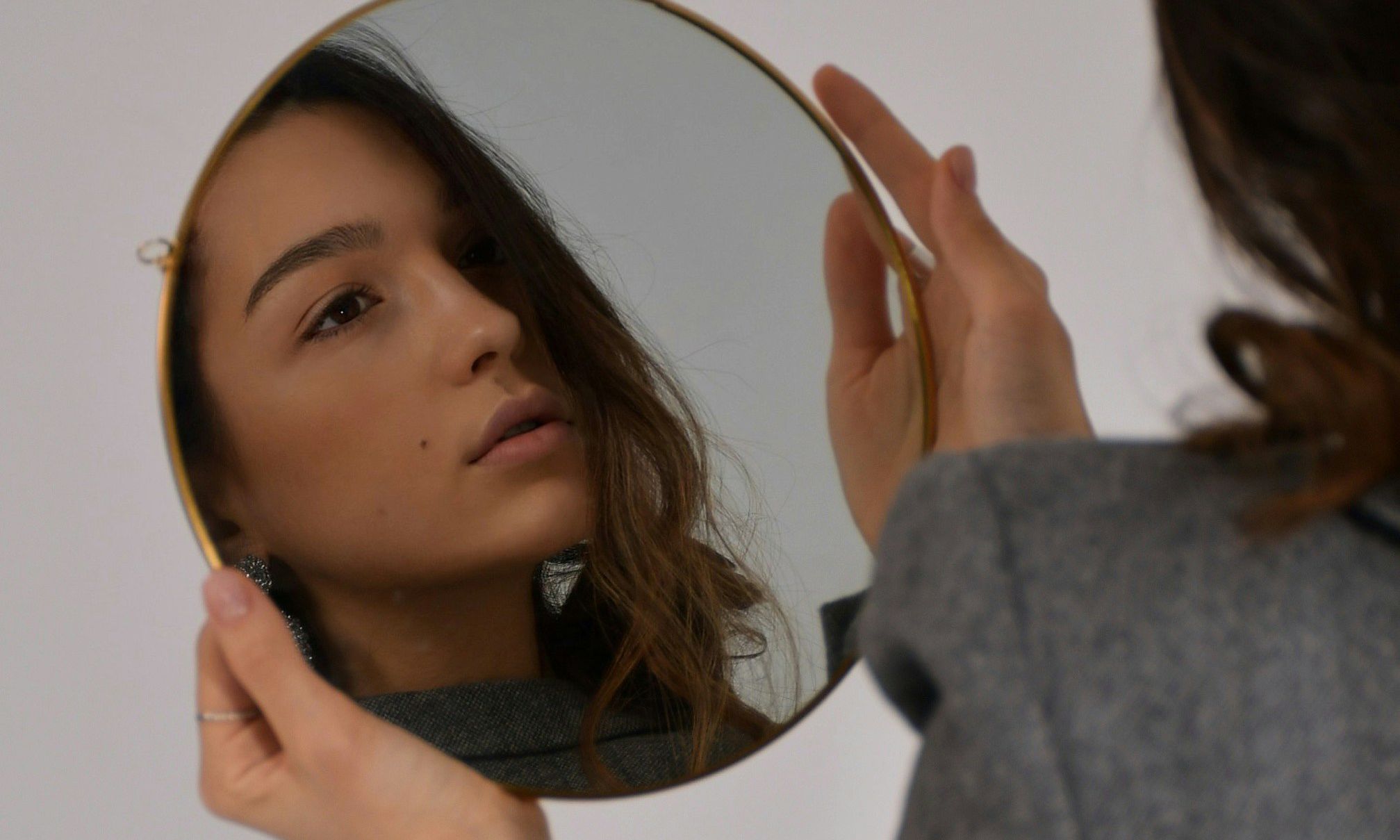 woman looking in mirror