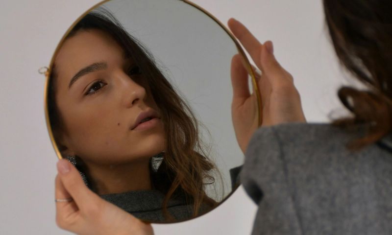 woman looking in mirror