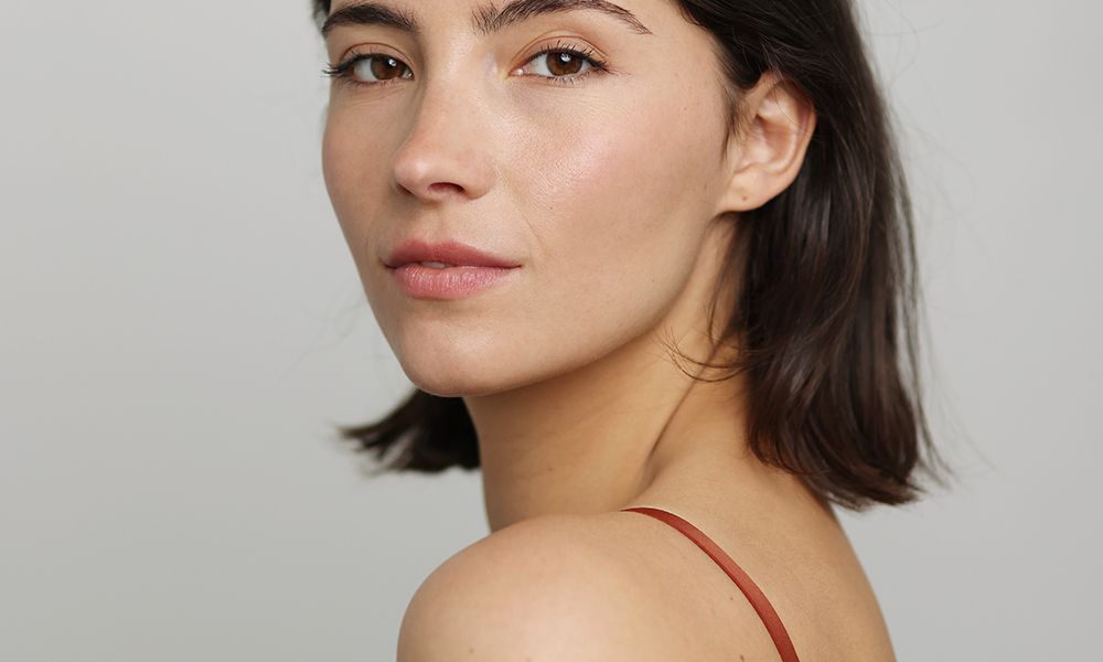 Beauty Portrait of a brunette beautiful woman posing in front of a neutral background - studio photo