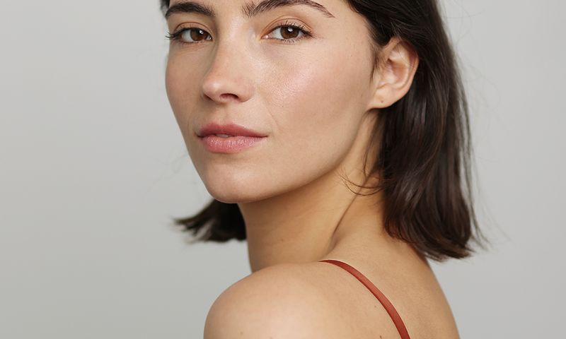 Beauty Portrait of a brunette beautiful woman posing in front of a neutral background - studio photo