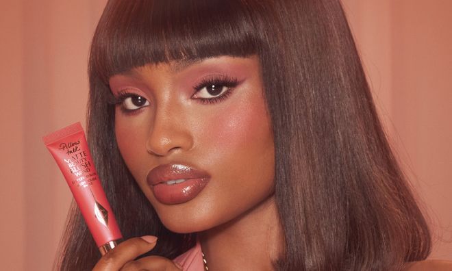 model wearing Charlotte Tilbury's Matte Beauty Blush Wand in Dream Pop