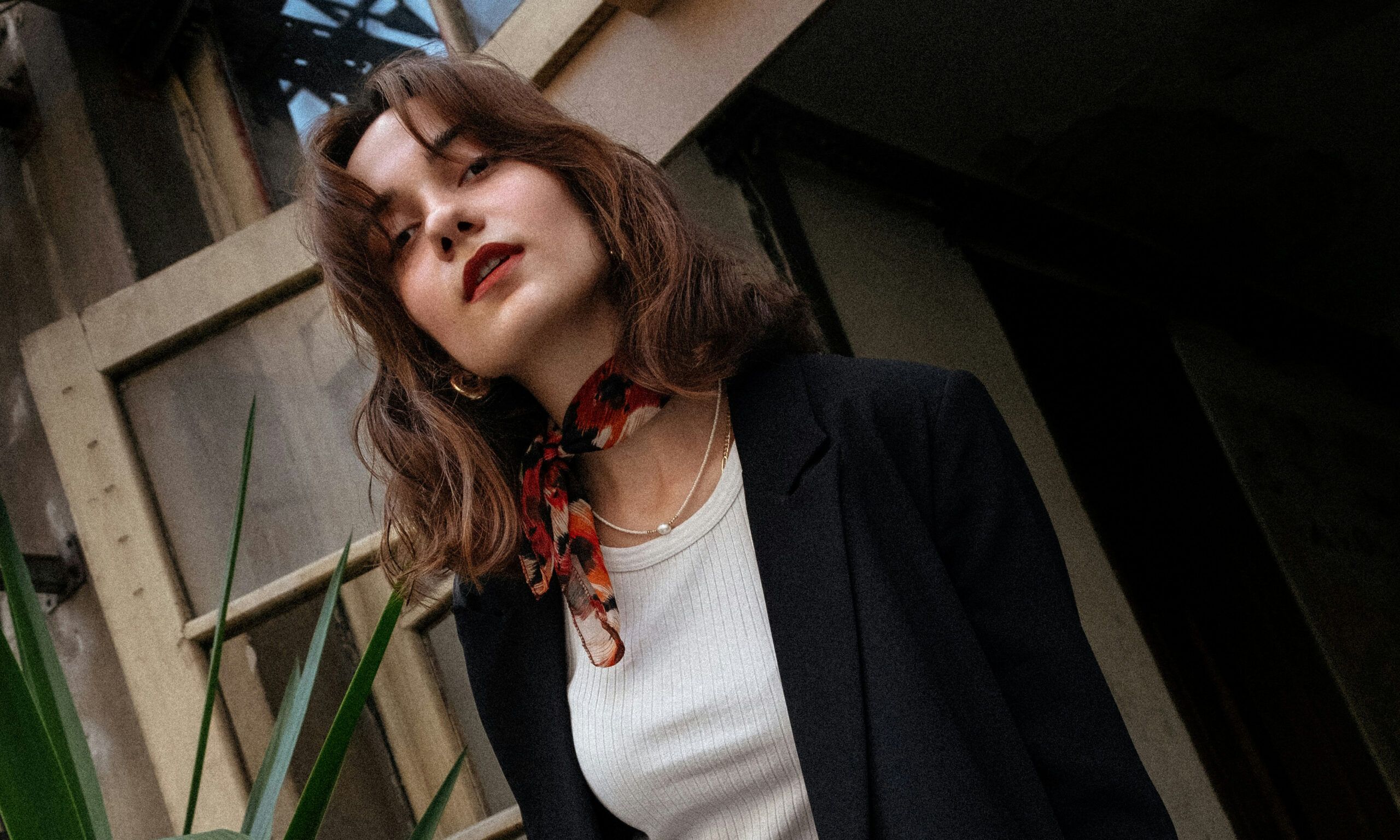 brunette woman wearing a black blazer and white shirt