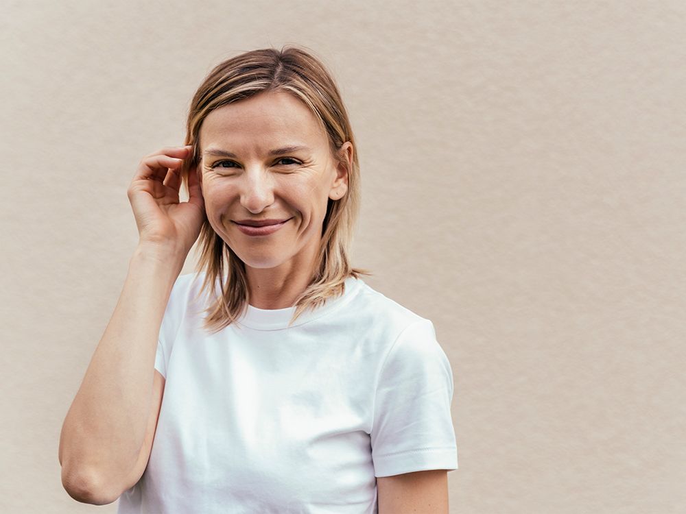 blonde haird woman in white t-shirt smiling