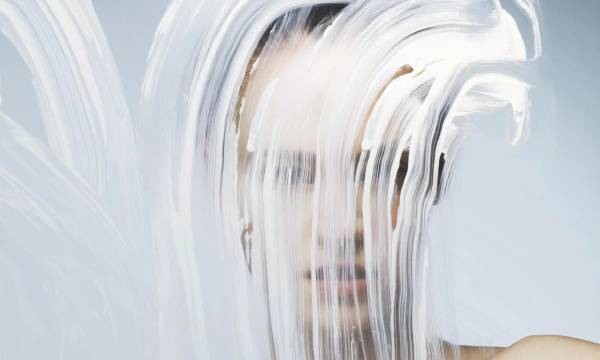 woman standing before a smeared glass