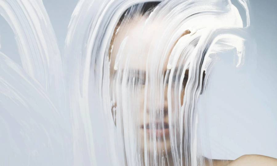 woman standing before a smeared glass