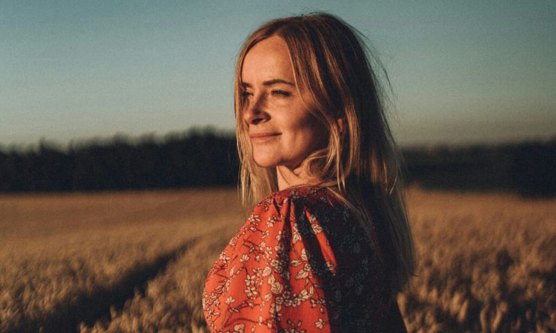woman in field at sunset
