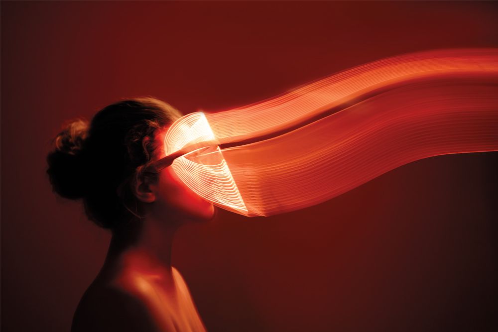 woman wearing red light mask
