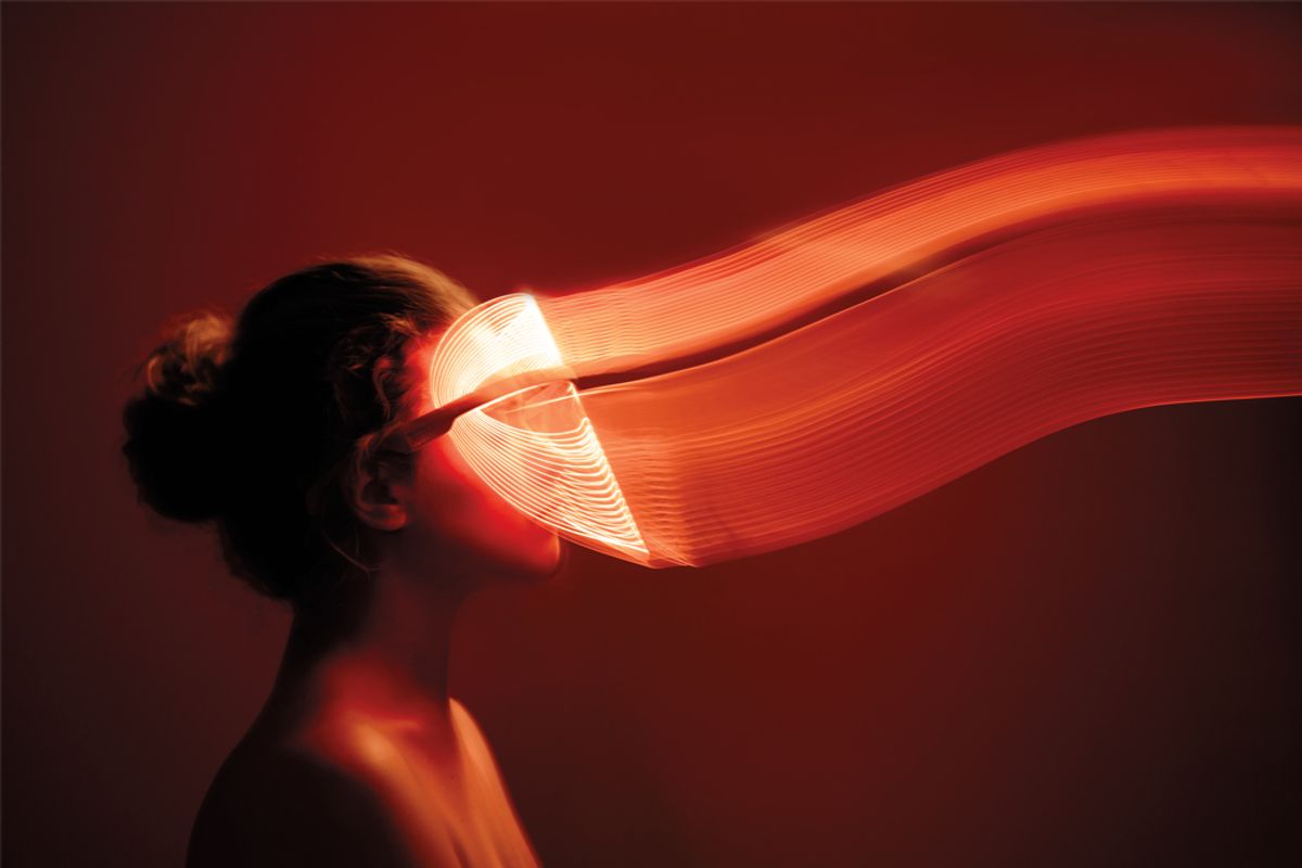 woman wearing red light mask