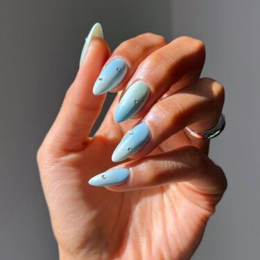 Long nails with baby blue polish and rhinestones
