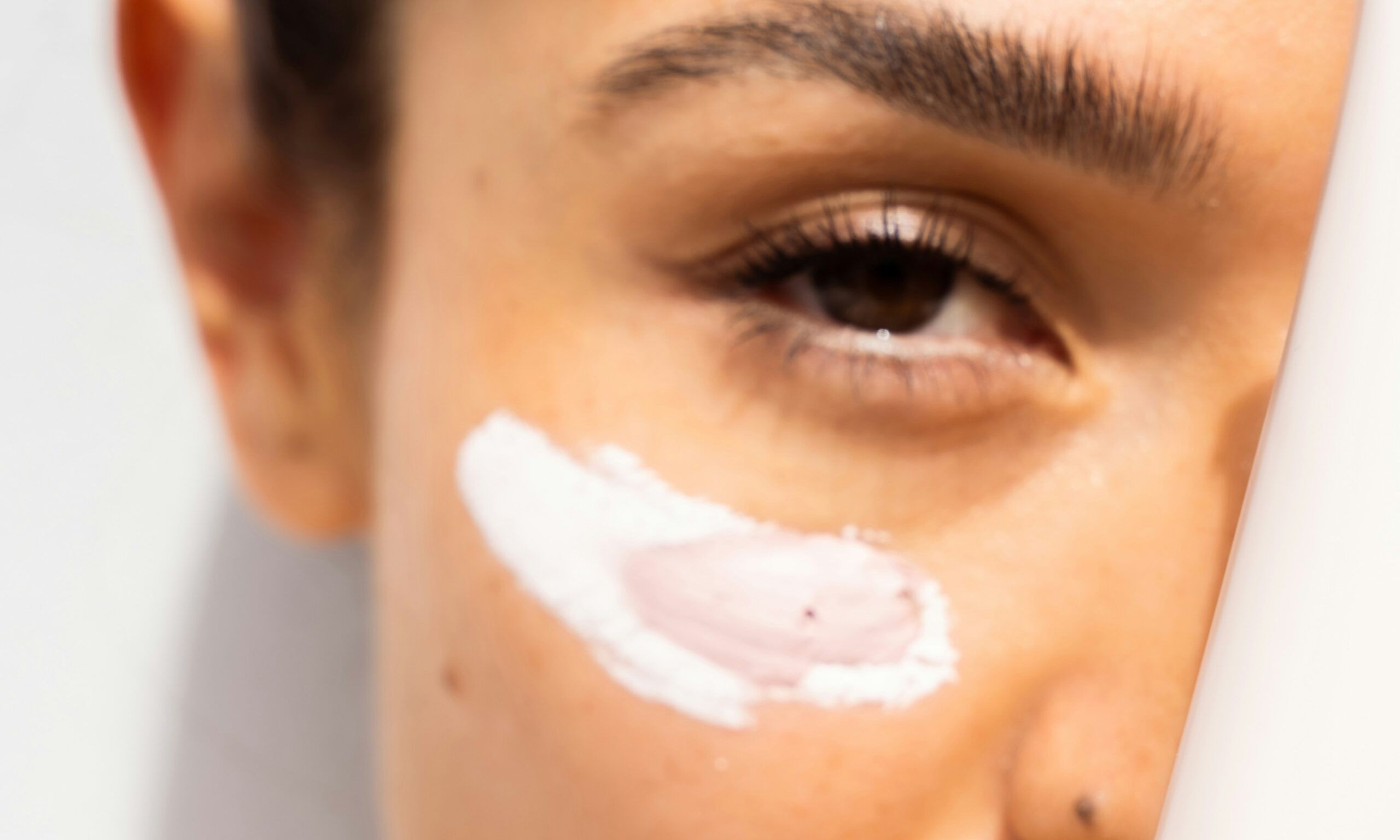 woman with skin care smear on cheek