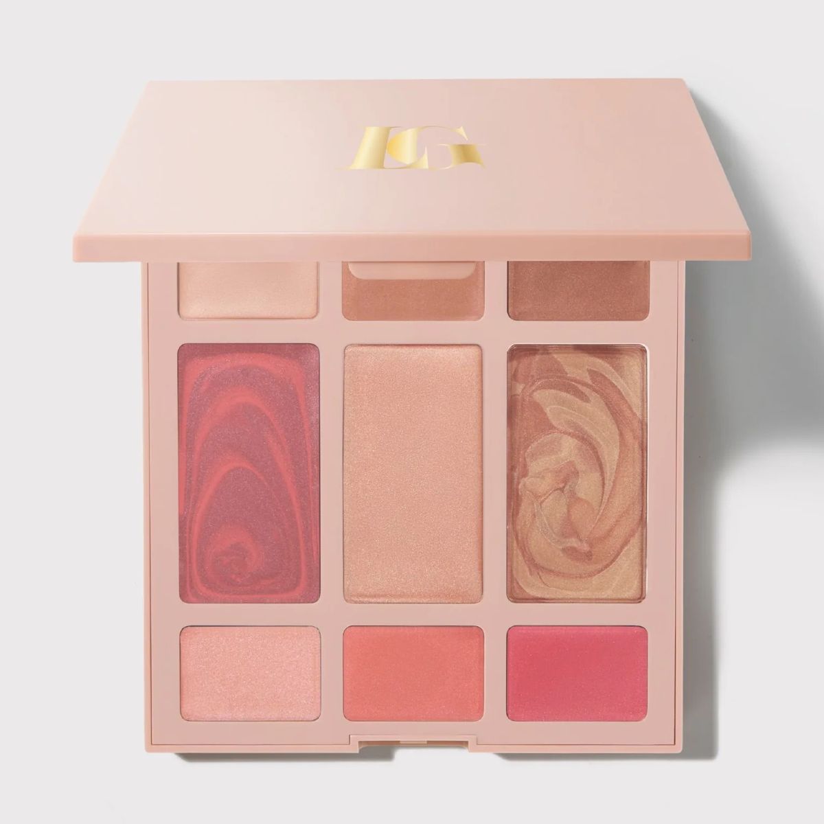 Laura Geller Best of the Best cream face palette featuring blush, bronzer, highlighter and eyeshadows in rosy and neutral tones, shown open against a light background.