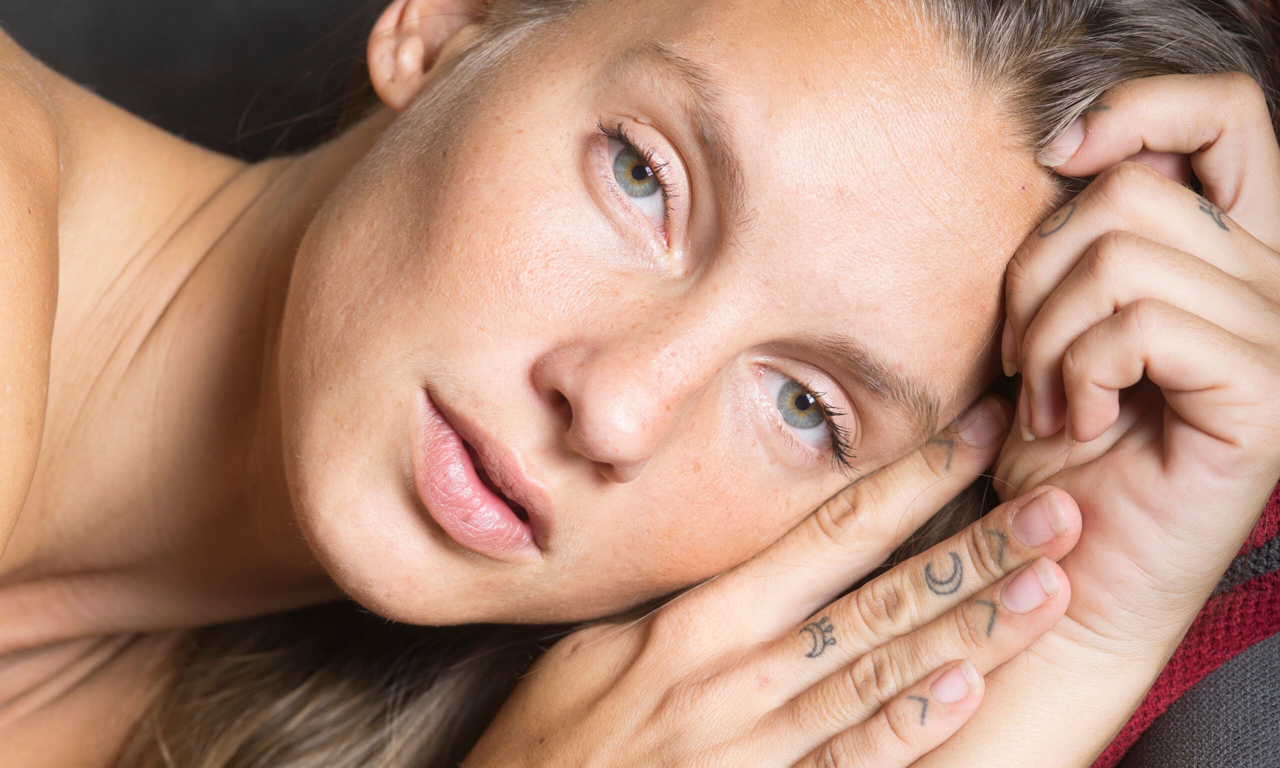 woman laying down looking at camera