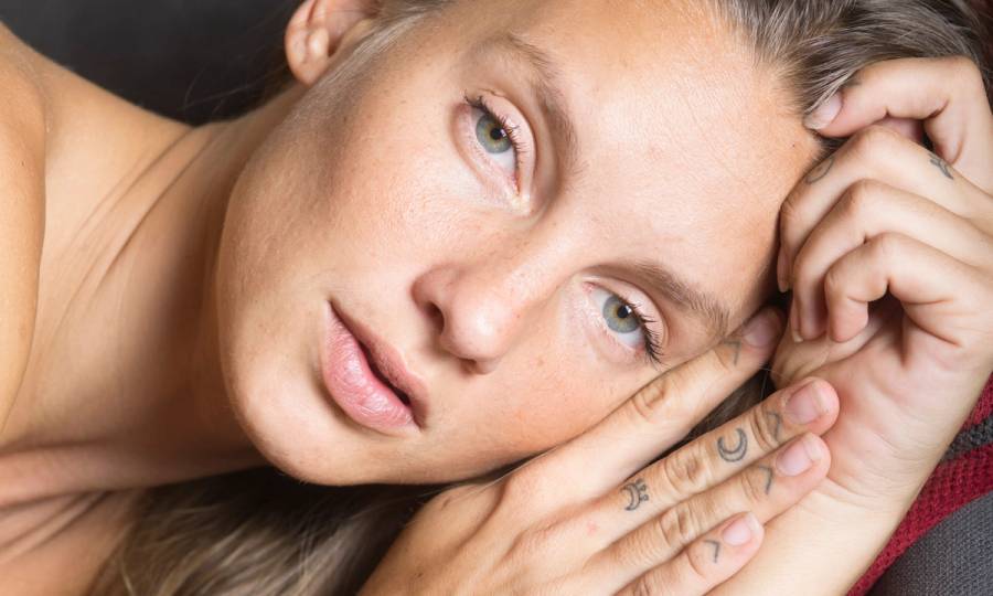 woman laying down looking at camera
