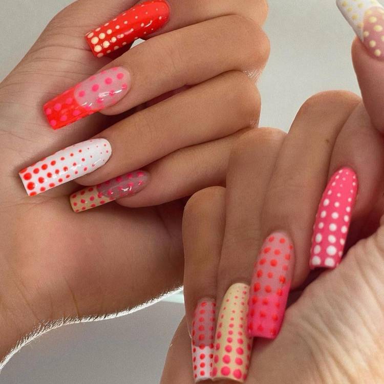 Kylie Jenner’s technicolor polka-dot manicure by celebrity manicurist Chaun Legend, featuring long coffin-shaped nails in neon pink, red, yellow and white with mismatched dotted designs.