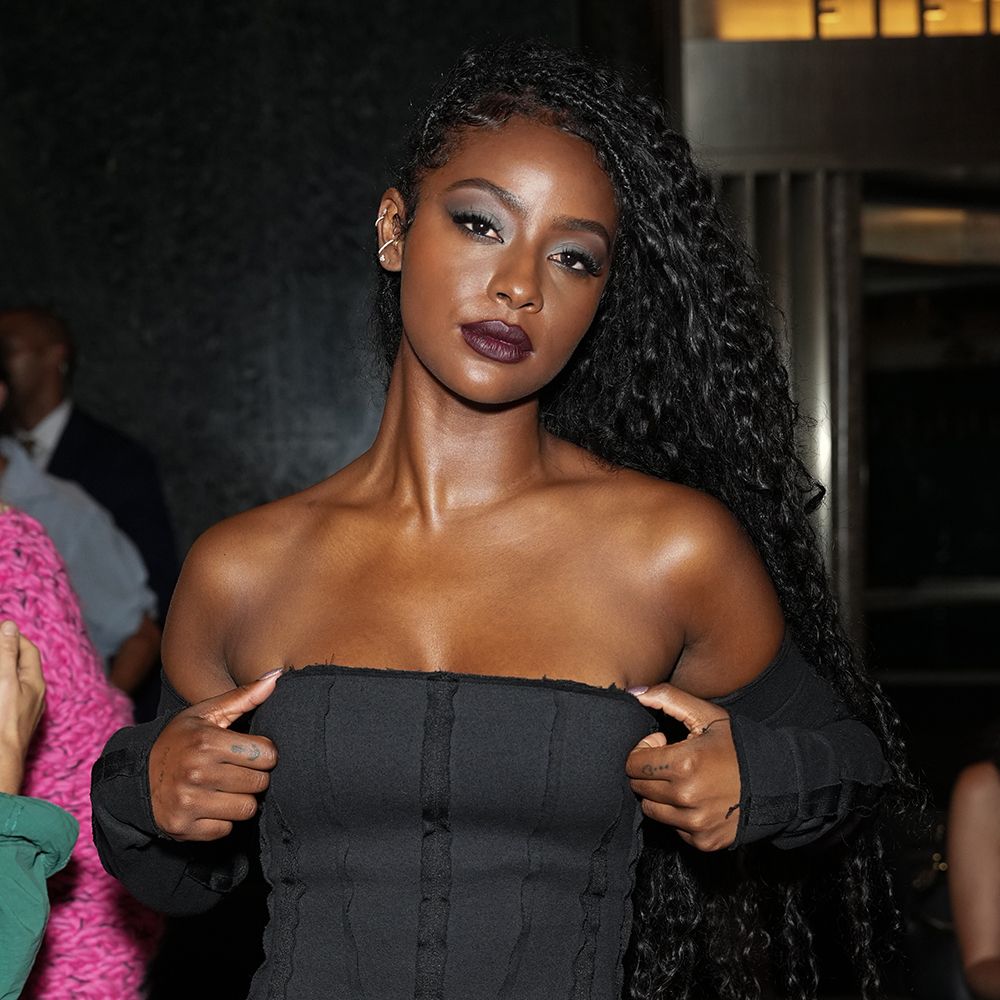 Photo of woman in black dress with long braids