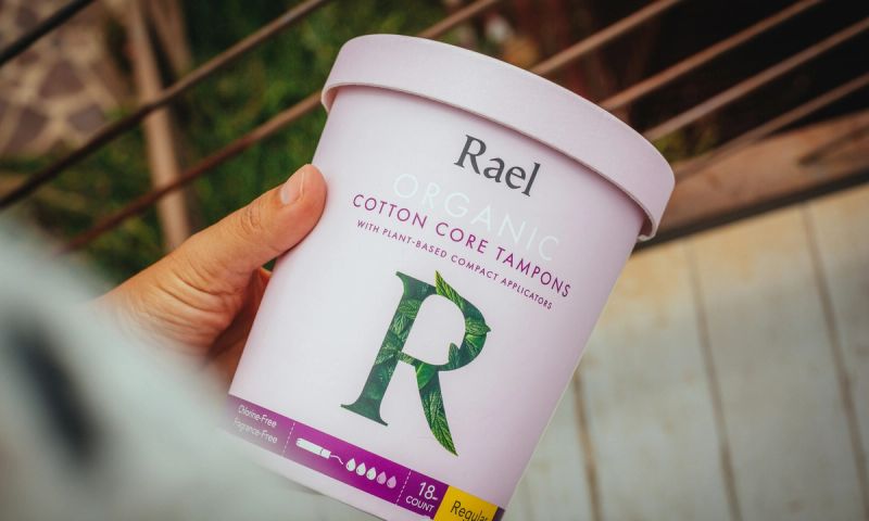photo of a person holding a container of Rael organic tampons