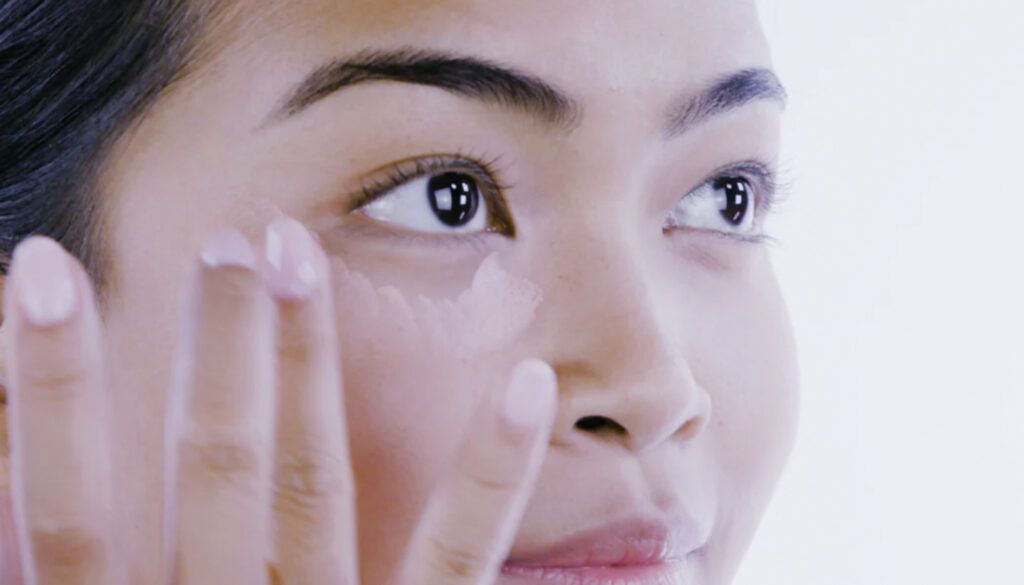 woman applying pixi color correction