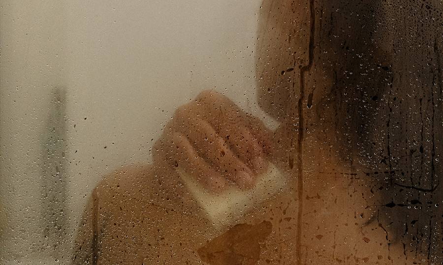 woman washing body in shower with bar soap