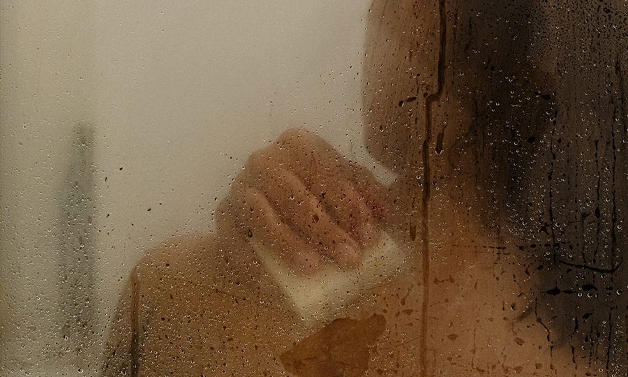 woman washing body in shower with bar soap
