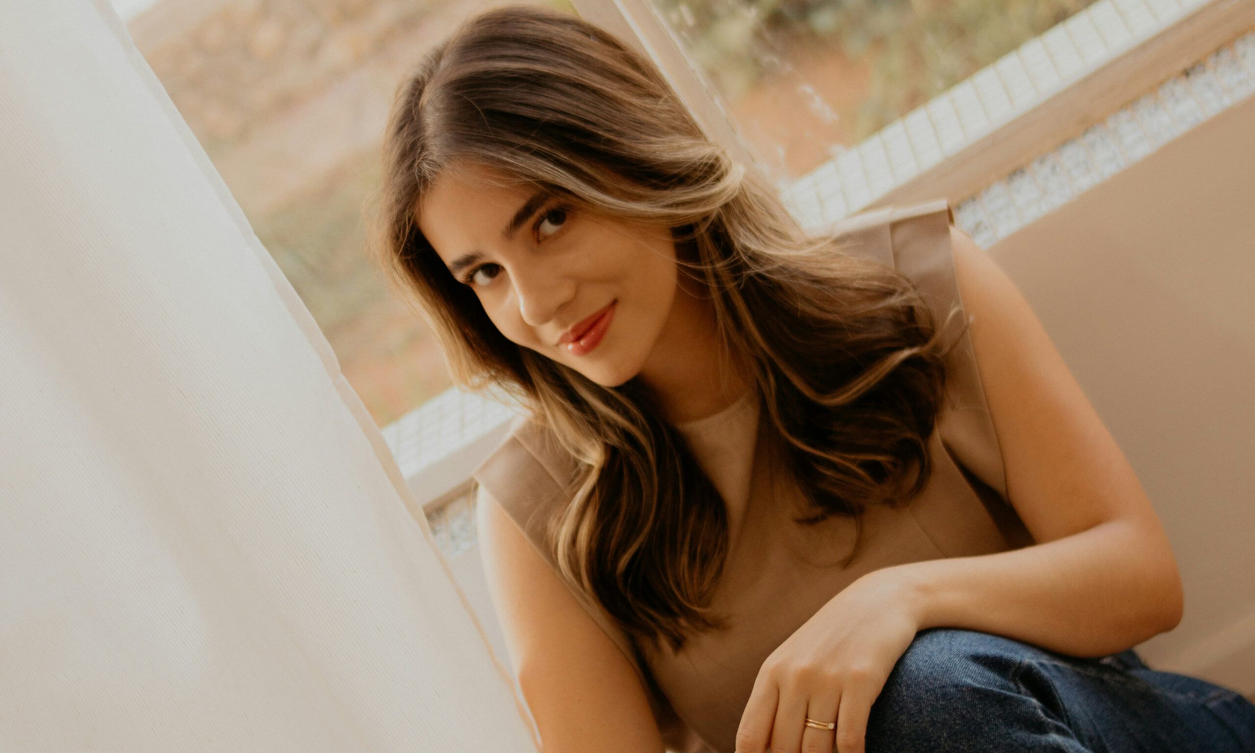 woman with pretty blow out sitting indoors