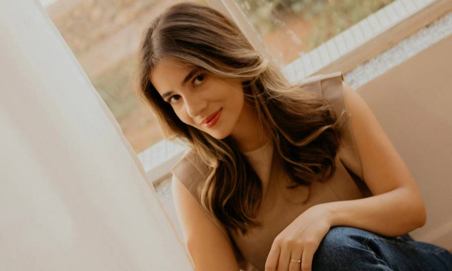 woman with pretty blow out sitting indoors