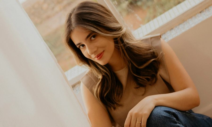 woman with pretty blow out sitting indoors